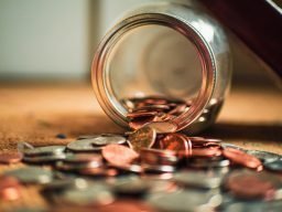 coins spilling out of jar