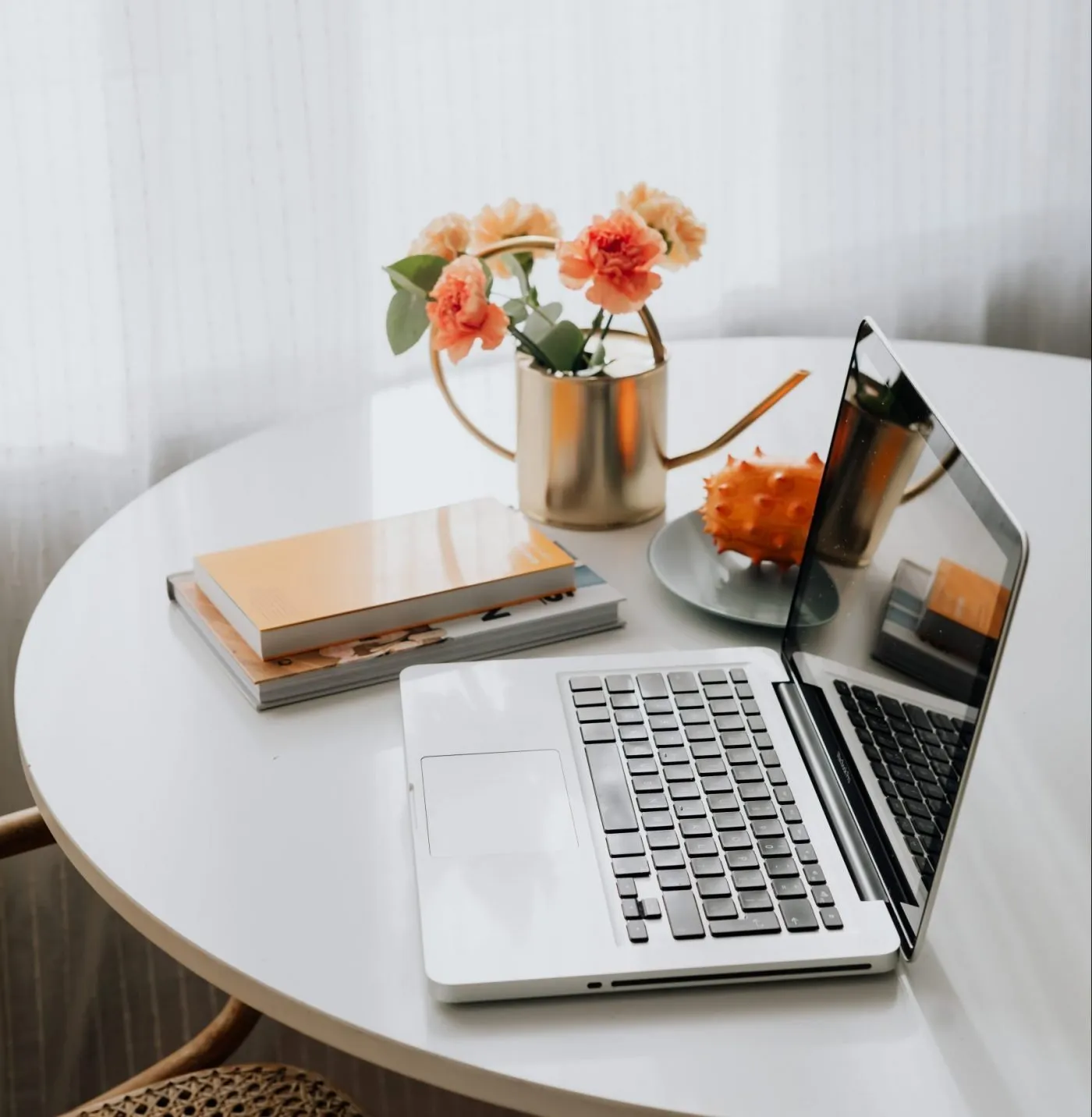 a laptop computer sitting on top of a white table.