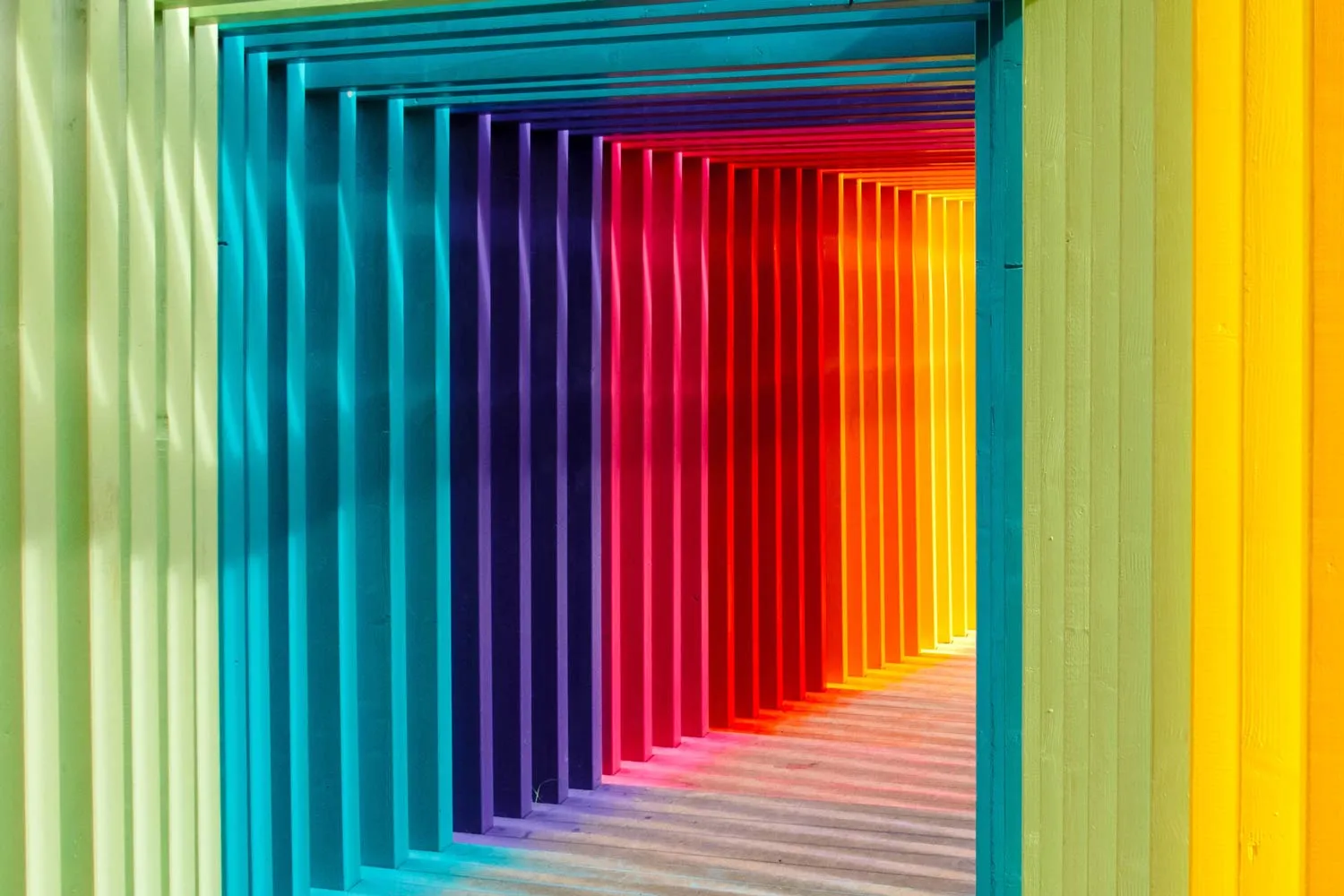 a row of multicolored plastic slats on a wall.