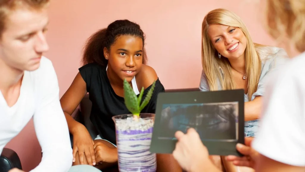 a group of people sitting around a table.