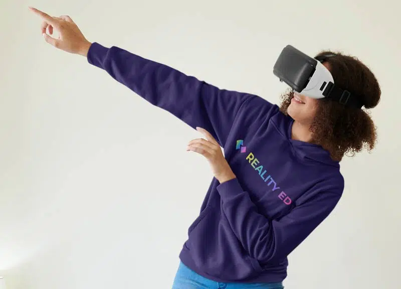 A woman wearing a purple hoodie pointing at something while offering her services.