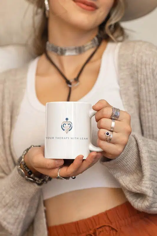 A woman holding a coffee mug with a crown logo on it, showcasing royalty and services