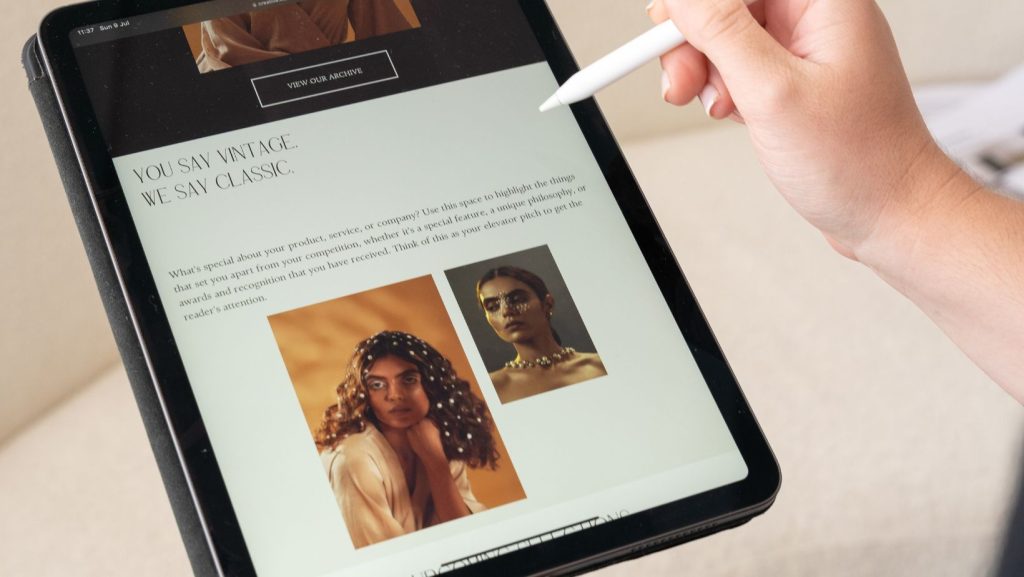 A hand holding a tablet with a stylus showcasing the branding created by a Branding Agency Guildford.