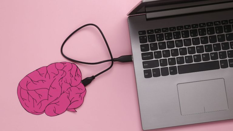 A laptop with a pink brain connected to it