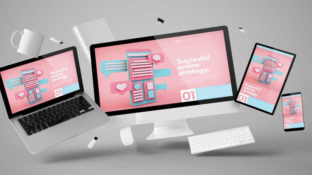 Multiple devices including a laptop, desktop monitor, smartphone, and tablet display a webpage titled "Successful Online Strategy" with a pink and blue color scheme. Various office items float around, highlighting the essential "Website Must-Haves".